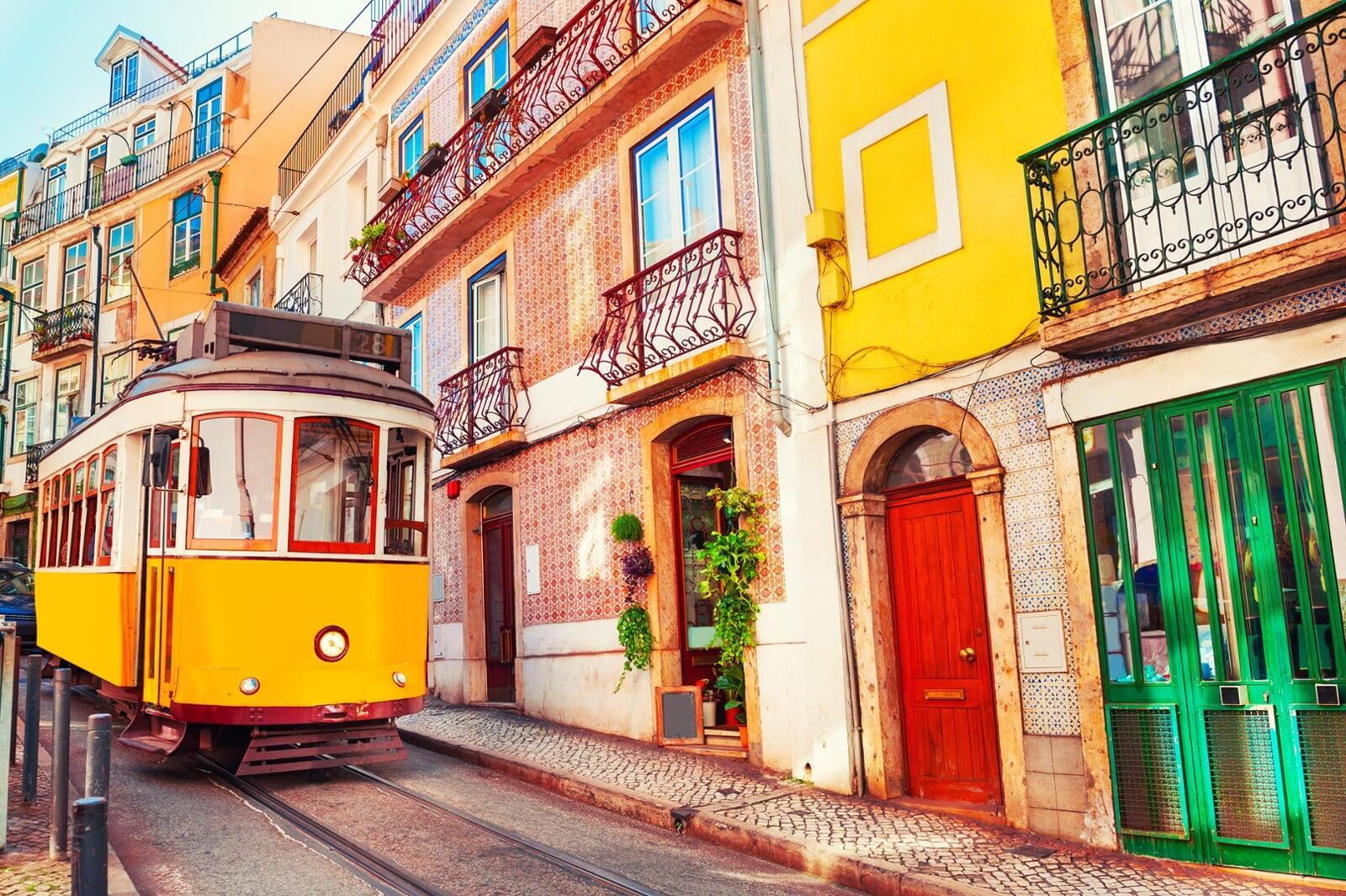 photo of colorful colombian houses with a colombia flag handing over
